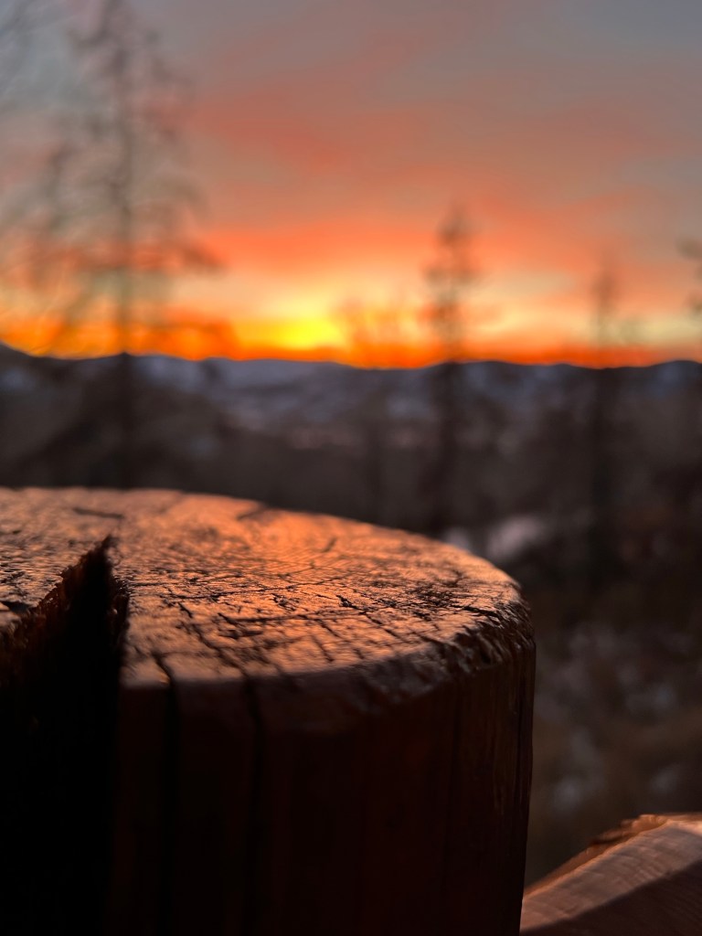 Sunset over a wood post